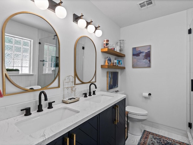 5553 S Delaware Ct, Tulsa, OK 74105 - bathroom with double vanity, toilet, and an enclosed shower