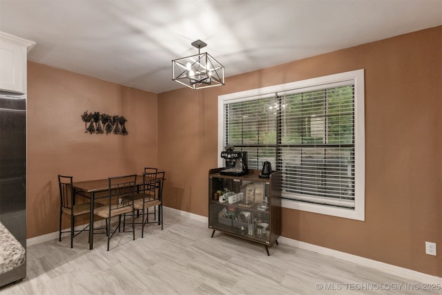 7423 S Urbana Ave, Tulsa, OK 74136 - dining space featuring a chandelier and baseboards