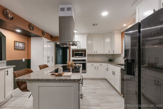 7423 S Urbana Ave, Tulsa, OK 74136 - kitchen featuring black appliances, island range hood, white cabinetry, decorative backsplash, and a kitchen island