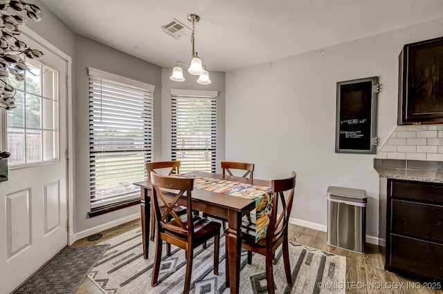 505 Teriwine, Perkins, OK 74059 - dining space featuring light wood-type flooring, baseboards, and a chandelier