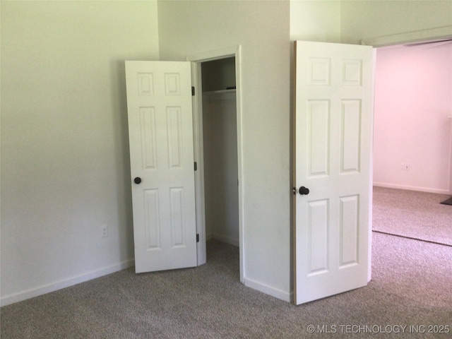 218 N Vann St, Pryor, OK 74361 - unfurnished bedroom featuring carpet, a closet, and baseboards