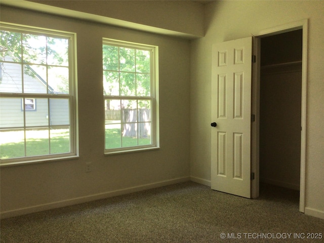 218 N Vann St, Pryor, OK 74361 - unfurnished bedroom with multiple windows and carpet flooring