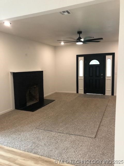 218 N Vann St, Pryor, OK 74361 - unfurnished living room with a ceiling fan, baseboards, and carpet