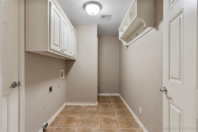 7416 W 40th St, Tulsa, OK 74107 - laundry room featuring electric dryer hookup, hookup for a washing machine, light tile patterned floors, baseboards, and cabinet space