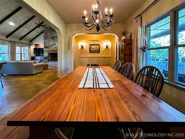 16012 N 145th Ave, Collinsville, OK 74021 - dining area with arched walkways, a chandelier, a fireplace, and finished concrete flooring