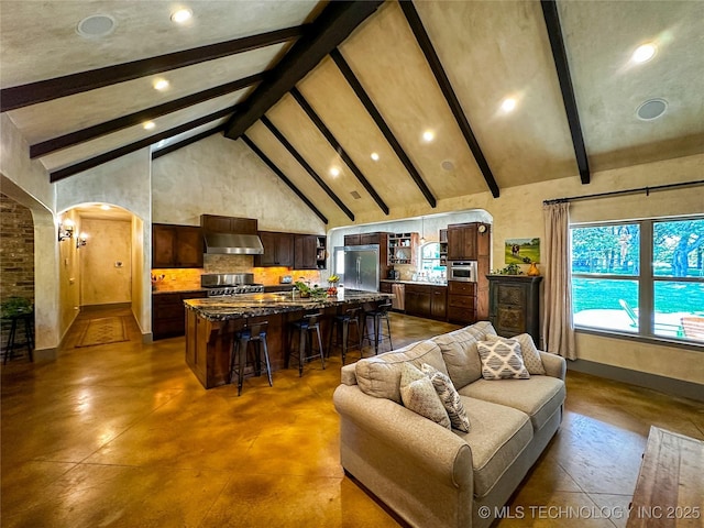16012 N 145th Ave, Collinsville, OK 74021 - living room featuring finished concrete floors, high vaulted ceiling, beam ceiling, arched walkways, and recessed lighting