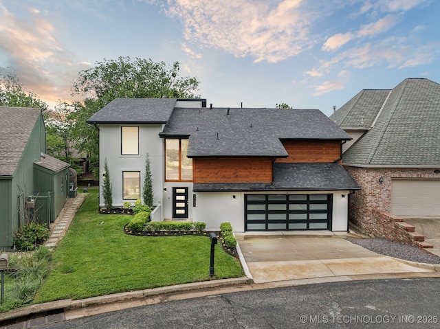 3735 E 64th Pl, Tulsa, OK 74136 - contemporary home featuring driveway, a lawn, roof with shingles, a garage, and stucco siding