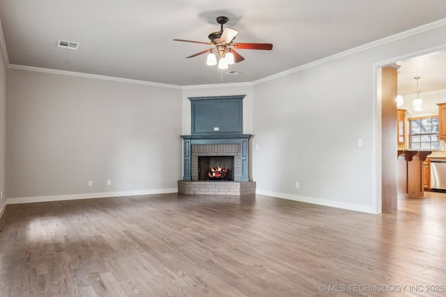 3200 Heritage Dr, Claremore, OK 74019 - unfurnished living room with a ceiling fan, wood finished floors, baseboards, a brick fireplace, and crown molding