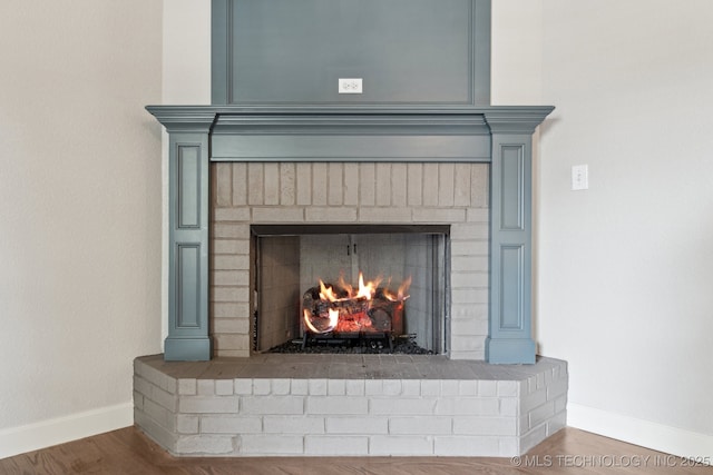 3200 Heritage Dr, Claremore, OK 74019 - detailed view of a brick fireplace, baseboards, and wood finished floors
