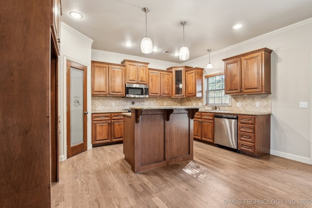 3200 Heritage Dr, Claremore, OK 74019 - kitchen featuring stainless steel appliances, brown cabinets, a breakfast bar area, light wood-style flooring, and crown molding