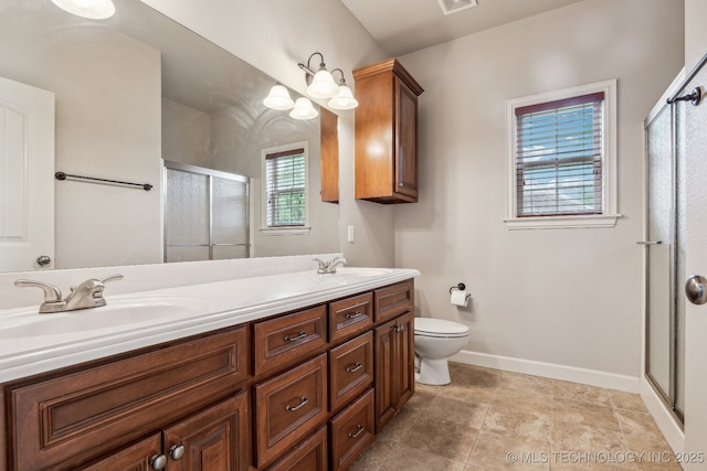 3200 Heritage Dr, Claremore, OK 74019 - bathroom featuring a stall shower, double vanity, toilet, and baseboards