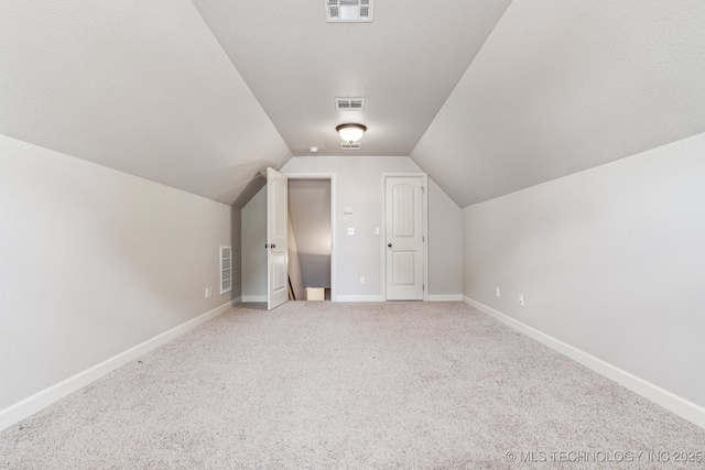 3200 Heritage Dr, Claremore, OK 74019 - bonus room with lofted ceiling, light colored carpet, and baseboards