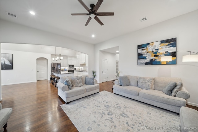 8721 E Joliet St, Broken Arrow, OK 74014 - living room with arched walkways, a ceiling fan, dark wood finished floors, baseboards, and recessed lighting