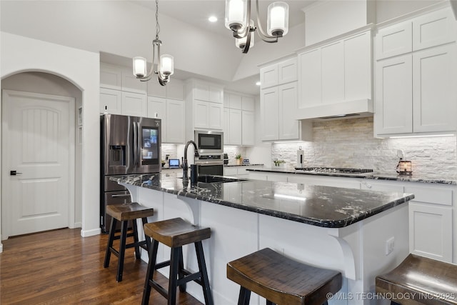 8721 E Joliet St, Broken Arrow, OK 74014 - kitchen featuring appliances with stainless steel finishes, a sink, a chandelier, backsplash, and lofted ceiling
