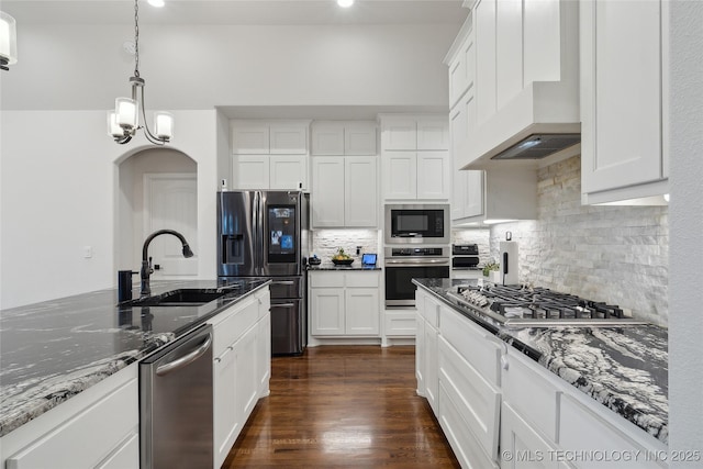 8721 E Joliet St, Broken Arrow, OK 74014 - kitchen with appliances with stainless steel finishes, a sink, custom range hood, tasteful backsplash, and dark stone counters
