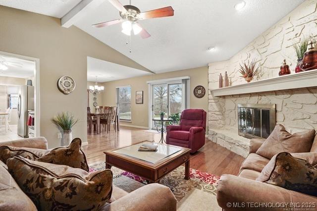 20941 E 102nd St S, Broken Arrow, OK 74014 - living room with ceiling fan, wood finished floors, a chandelier, and a fireplace