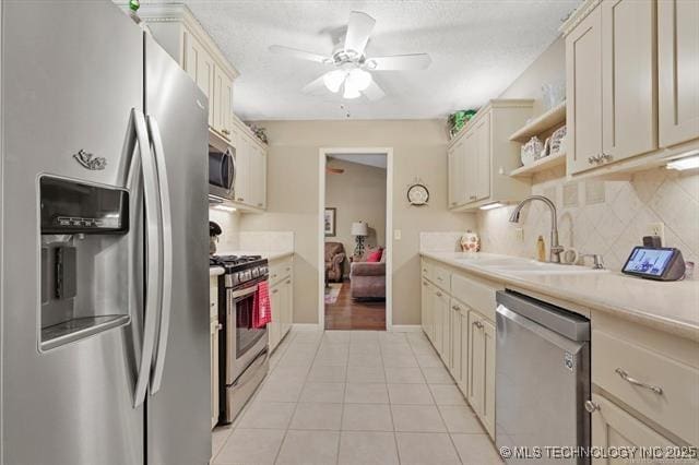 20941 E 102nd St S, Broken Arrow, OK 74014 - kitchen featuring stainless steel appliances, a sink, ceiling fan, light tile patterned floors, and light countertops