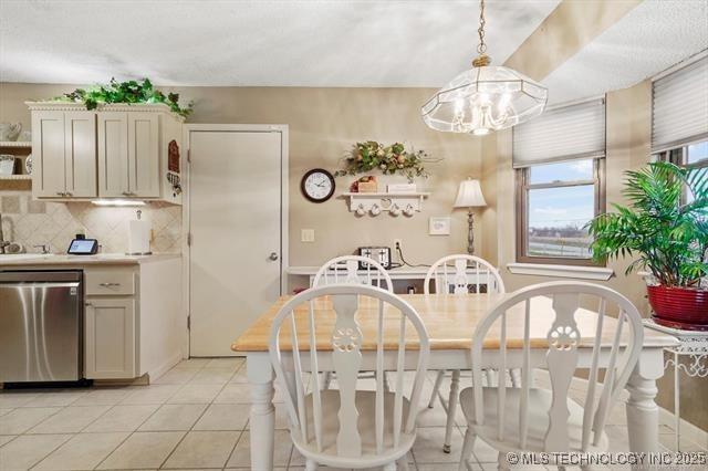 20941 E 102nd St S, Broken Arrow, OK 74014 - dining space with a chandelier and light tile patterned floors