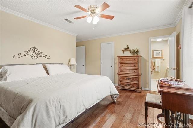 20941 E 102nd St S, Broken Arrow, OK 74014 - bedroom with wood finished floors, ornamental molding, and a ceiling fan