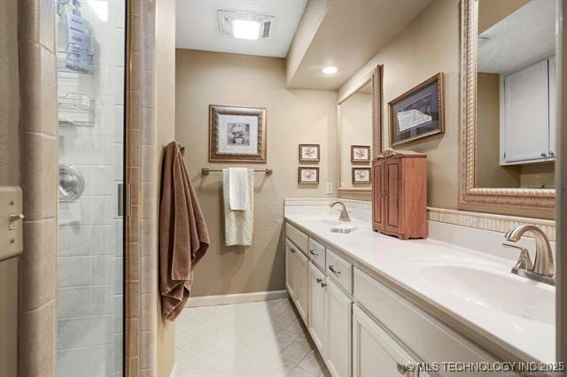 20941 E 102nd St S, Broken Arrow, OK 74014 - full bathroom featuring double vanity, tiled shower, tile patterned flooring, baseboards, and recessed lighting