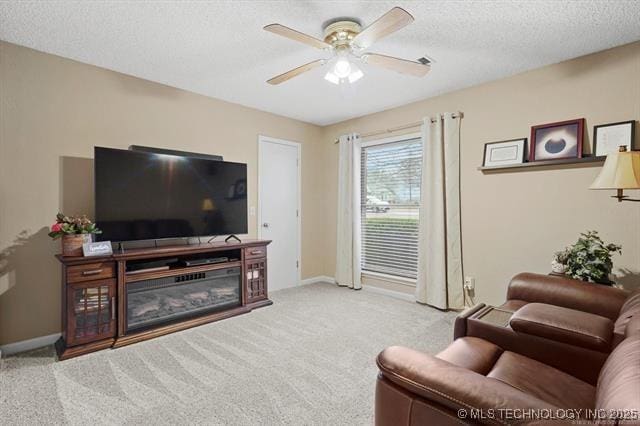 20941 E 102nd St S, Broken Arrow, OK 74014 - carpeted living room featuring a ceiling fan, a textured ceiling, baseboards, and a glass covered fireplace