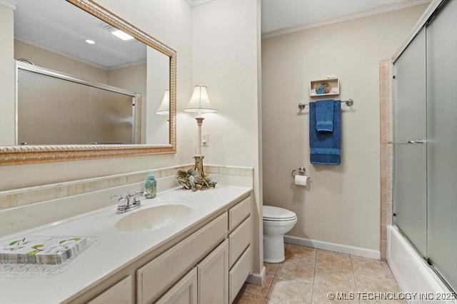 20941 E 102nd St S, Broken Arrow, OK 74014 - full bath with vanity, toilet, crown molding, enclosed tub / shower combo, and baseboards