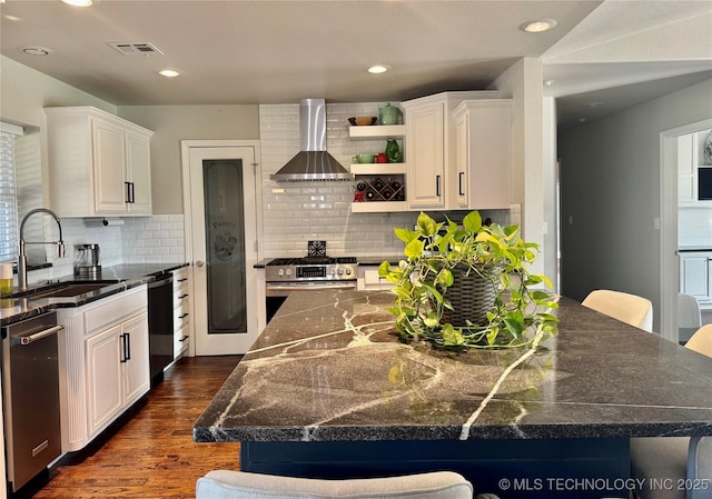 74232 S 320th Rd, Wagoner, OK 74467 - kitchen with wall chimney range hood, a sink, appliances with stainless steel finishes, dark wood finished floors, and white cabinets