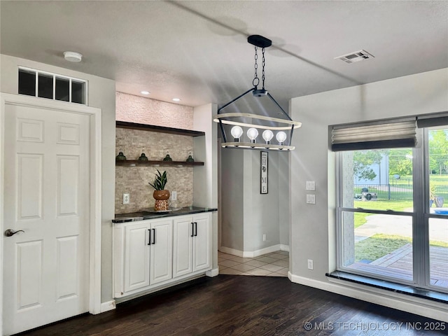 74232 S 320th Rd, Wagoner, OK 74467 - bar featuring dark wood finished floors, baseboards, decorative backsplash, and decorative light fixtures