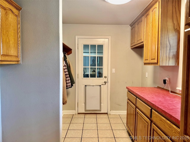 74232 S 320th Rd, Wagoner, OK 74467 - laundry area with light tile patterned floors and baseboards