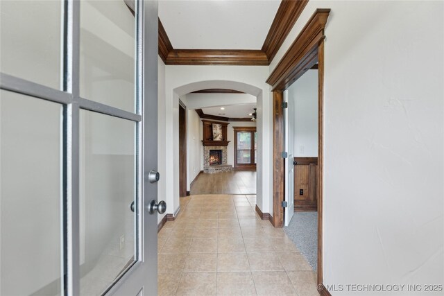 7083 E 85th St N, Owasso, OK 74055 - corridor featuring crown molding, arched walkways, light tile patterned flooring, and baseboards