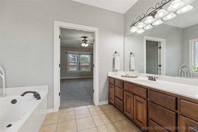 7083 E 85th St N, Owasso, OK 74055 - bathroom with double vanity, a garden tub, ceiling fan, tile patterned floors, and baseboards