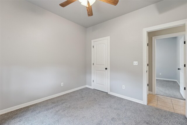 7083 E 85th St N, Owasso, OK 74055 - spare room featuring light colored carpet, a ceiling fan, baseboards, and light tile patterned flooring