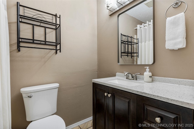 full bathroom with toilet and vanity