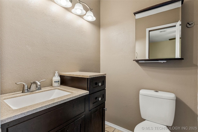 half bathroom with toilet and vanity