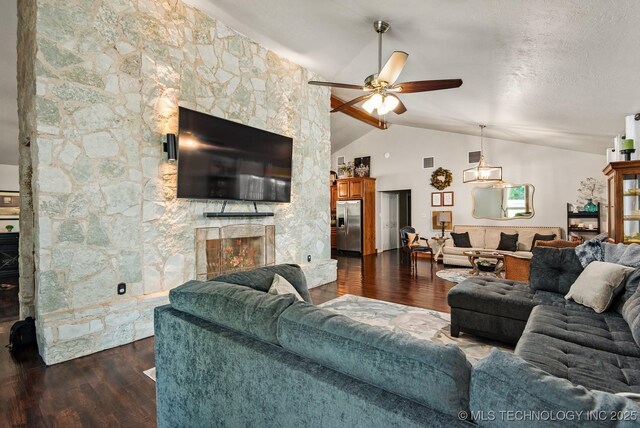 1300 S Mississippi, Ada, OK 74820 - living room featuring a fireplace, lofted ceiling, a ceiling fan, and dark wood-style floors