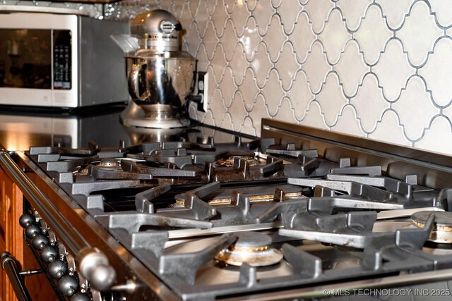 1300 S Mississippi, Ada, OK 74820 - kitchen view of stainless steel microwave and gas stove