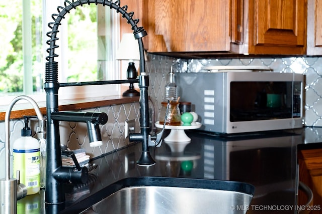 1300 S Mississippi, Ada, OK 74820 - kitchen view of backsplash, brown cabinets, and dark countertops