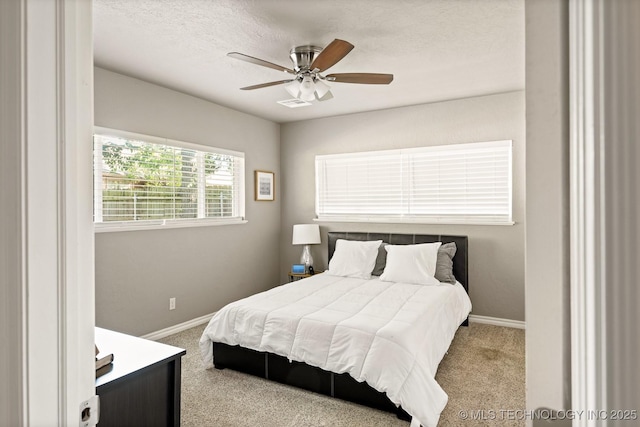 1300 S Mississippi, Ada, OK 74820 - bedroom featuring carpet floors, baseboards, ceiling fan, and a textured ceiling