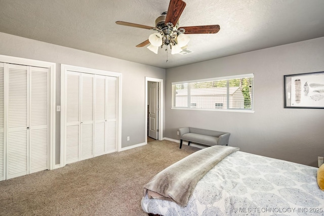 1300 S Mississippi, Ada, OK 74820 - bedroom featuring multiple closets, carpet flooring, ceiling fan, baseboards, and a textured ceiling