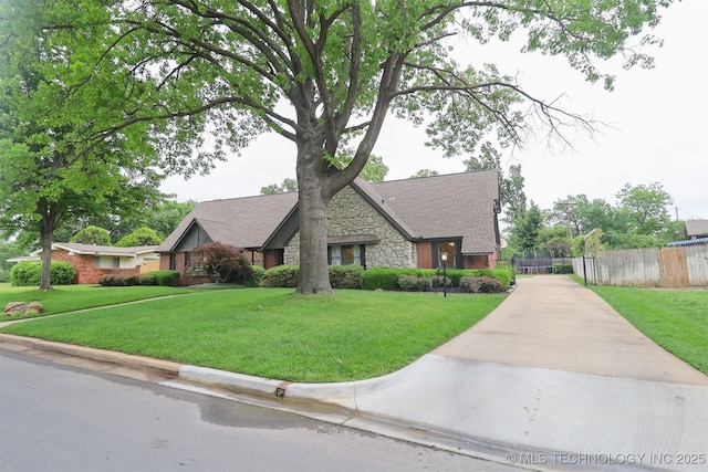5529 S New Haven Ave, Tulsa, OK 74135 - view of front facade featuring stone siding, driveway, and brick siding