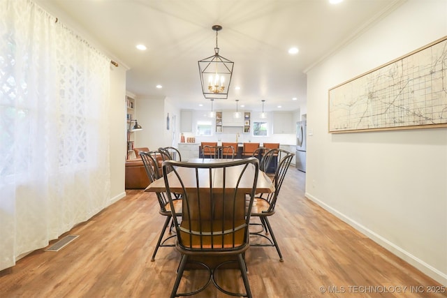 5529 S New Haven Ave, Tulsa, OK 74135 - dining room with baseboards, light wood-style flooring, crown molding, and recessed lighting