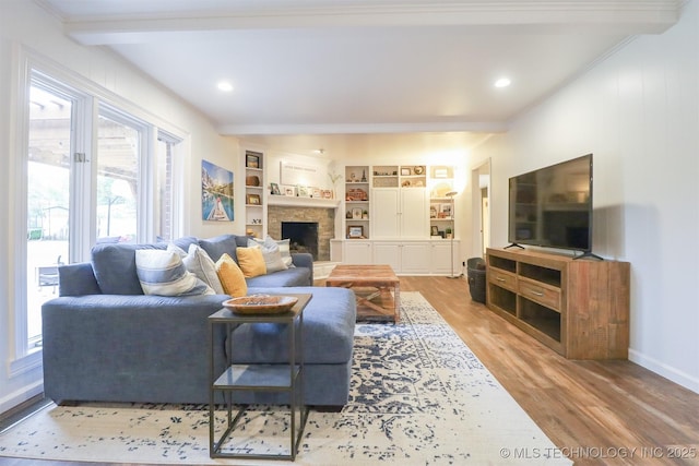 5529 S New Haven Ave, Tulsa, OK 74135 - living room featuring beam ceiling, wood finished floors, a fireplace, baseboards, and recessed lighting