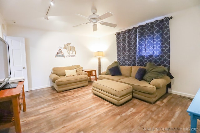 5529 S New Haven Ave, Tulsa, OK 74135 - living area with a ceiling fan, wood finished floors, baseboards, and rail lighting