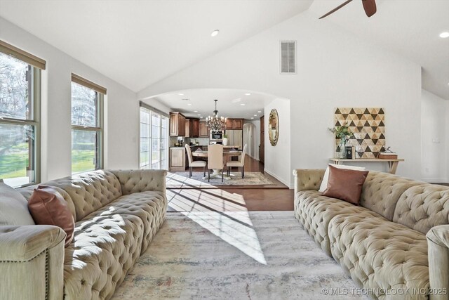 15209 S 89th W Ave, Sapulpa, OK 74066 - living room with arched walkways, a chandelier, light wood-style flooring, high vaulted ceiling, and recessed lighting