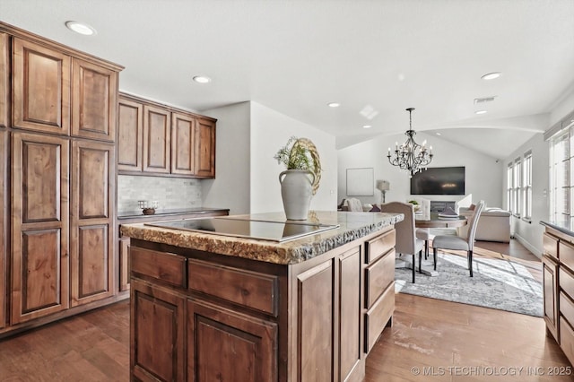 15209 S 89th W Ave, Sapulpa, OK 74066 - kitchen featuring a kitchen island, dark wood finished floors, open floor plan, black electric stovetop, and decorative backsplash