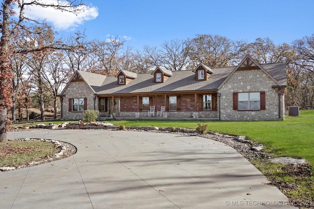 15209 S 89th W Ave, Sapulpa, OK 74066 - view of front of house featuring brick siding, curved driveway, a front yard, and central air condition unit