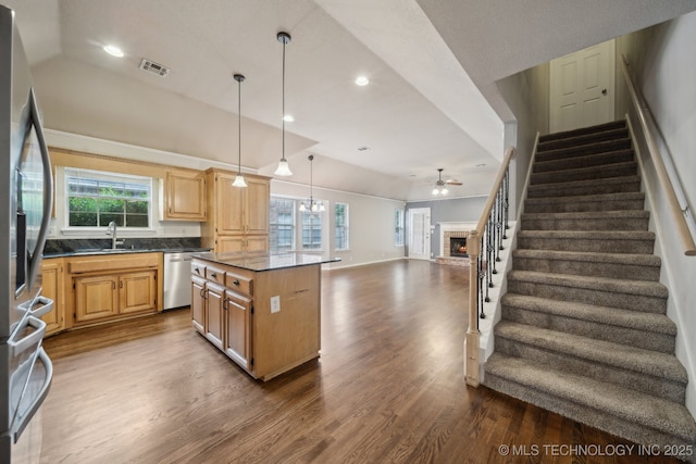 408 S Tamarack Ave, Broken Arrow, OK 74012 - kitchen featuring dark countertops, dark wood finished floors, stainless steel appliances, a fireplace, and ceiling fan
