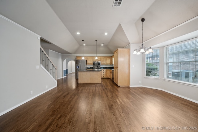408 S Tamarack Ave, Broken Arrow, OK 74012 - kitchen with appliances with stainless steel finishes, open floor plan, arched walkways, dark countertops, and light brown cabinets