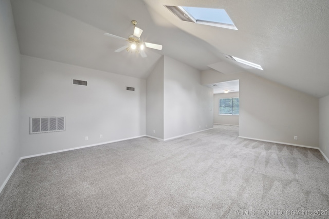 408 S Tamarack Ave, Broken Arrow, OK 74012 - additional living space with a skylight, carpet flooring, lofted ceiling, and a ceiling fan