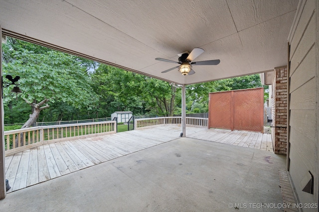 408 S Tamarack Ave, Broken Arrow, OK 74012 - fenced backyard with a shed, a wooden deck, a ceiling fan, view of scattered trees, and a patio area